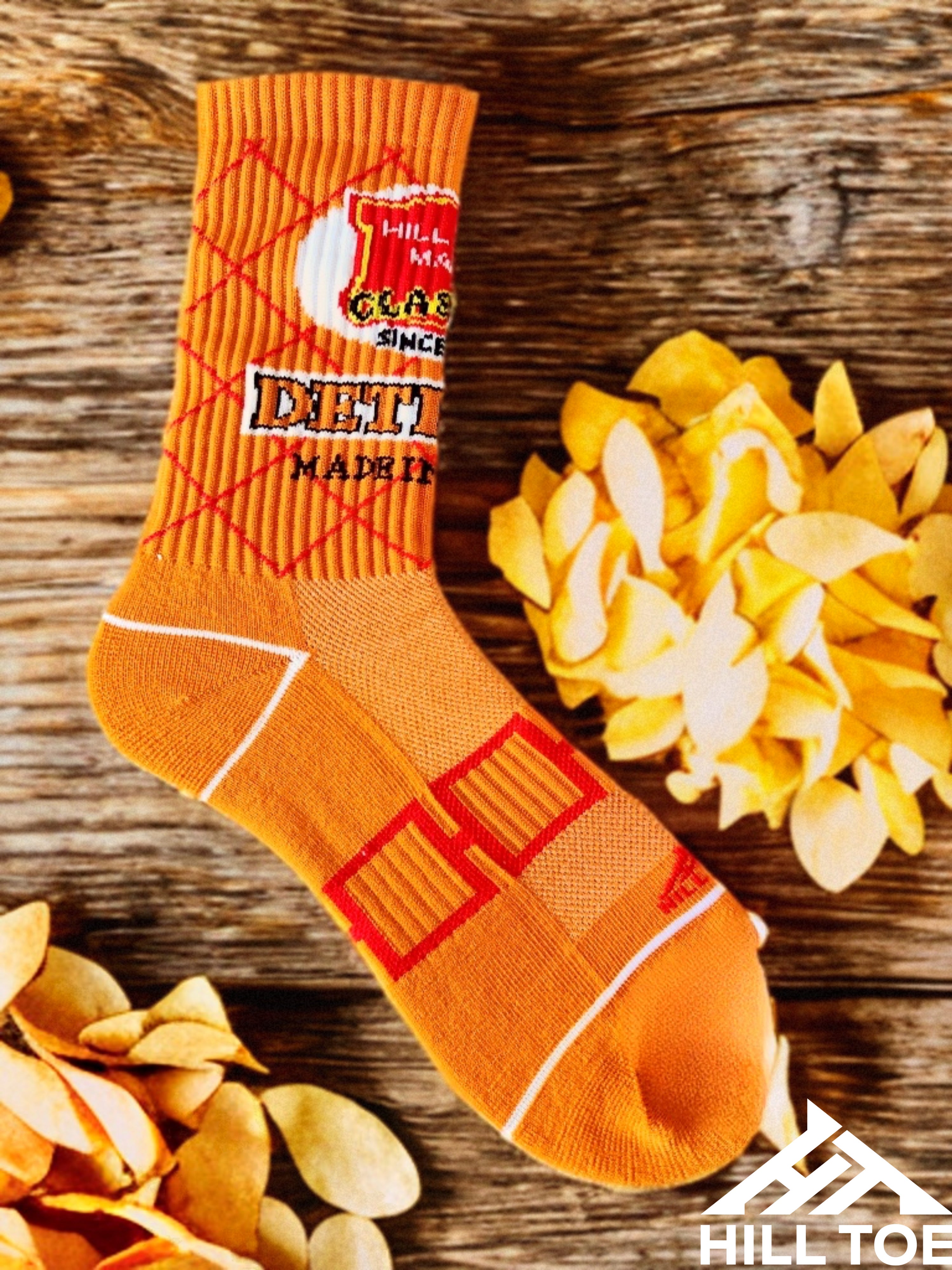 Hill Toe Chip Off the Sole sock in smoky red and charcoal tones, inspired by classic BBQ chip vibes, with performance-focused features.