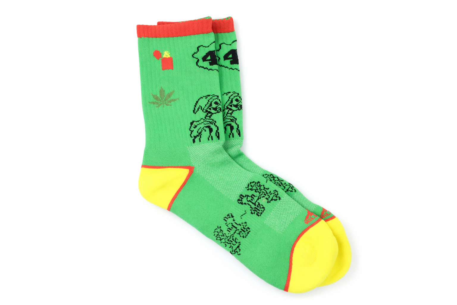 Green sock with black designs and red and yellow accents on a white background