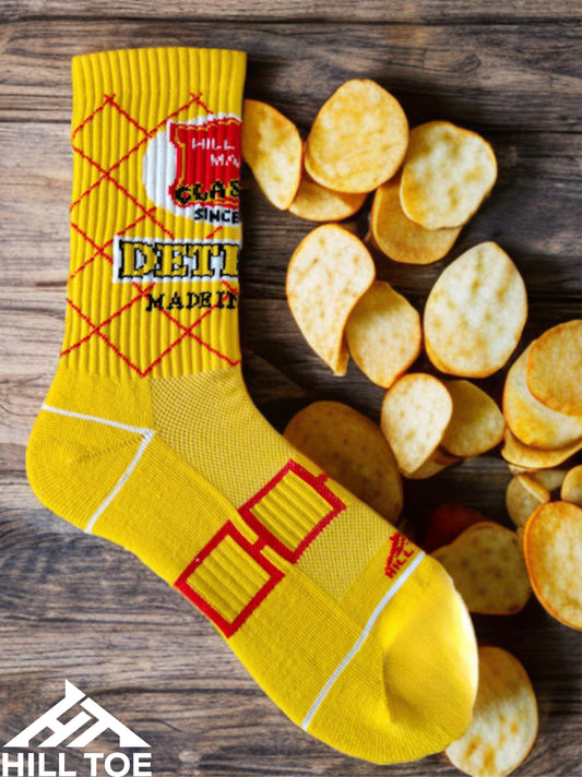 Hill Toe Chip Off the Sole sock in yellow and red colorway, inspired by Detroit’s original salted potato chips, featuring seamless toe and mesh instep.